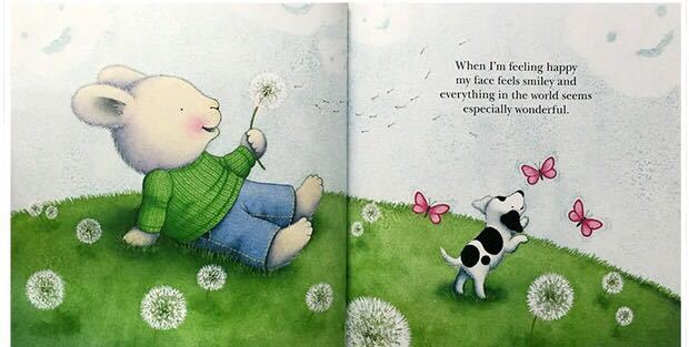 Illustrated book page with a bear and dog on a grassy field with dandelions.
