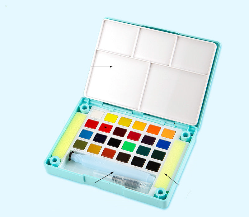 Set of watercolor paints in a portable case on a light blue background