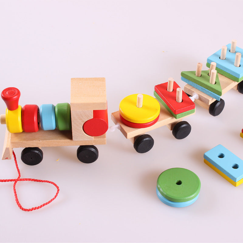 Colorful wooden toy train set on a white background