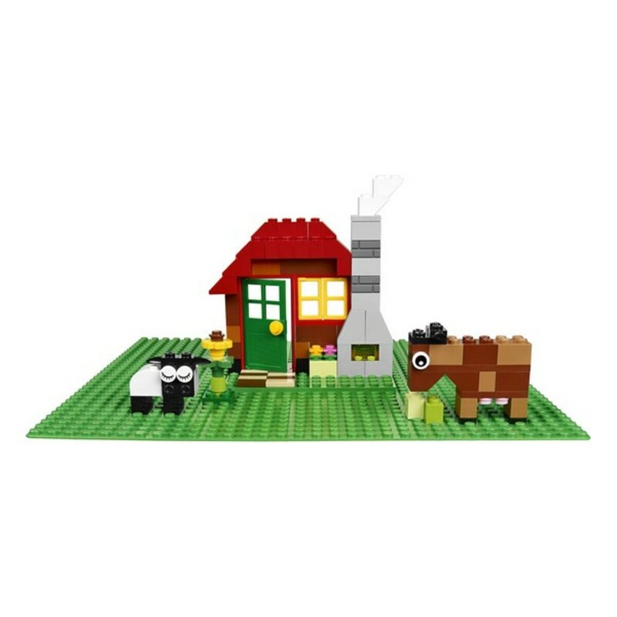 LEGO model of a house with animals on a green baseplate