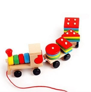 Colorful wooden toy train with a red string on a white background