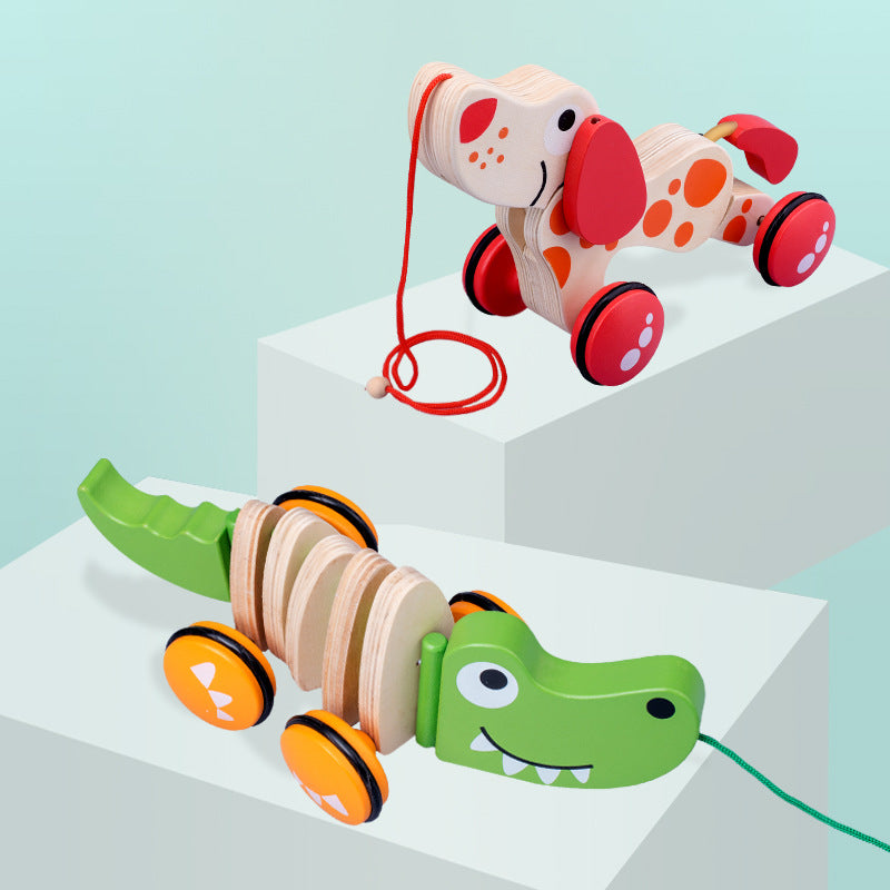 Wooden pull toys shaped like a dog and a crocodile on a light blue background