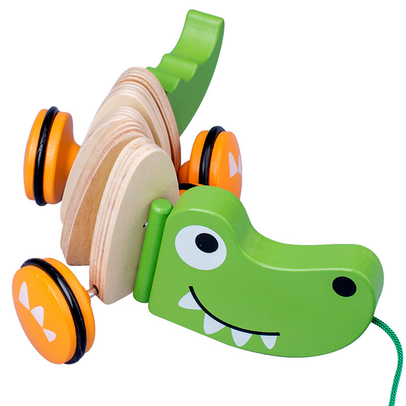 Green wooden toy with wheels on a white background