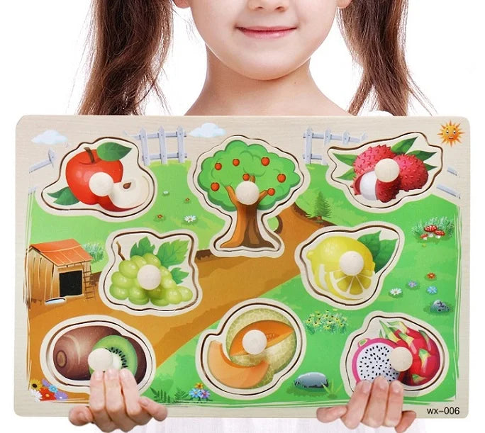 Child holding a wooden puzzle with fruit illustrations