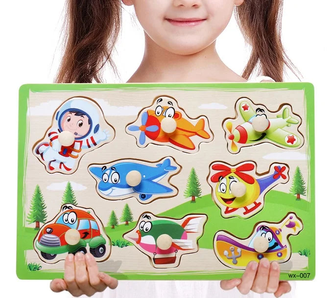 Child holding a wooden puzzle with colorful transportation-themed pieces