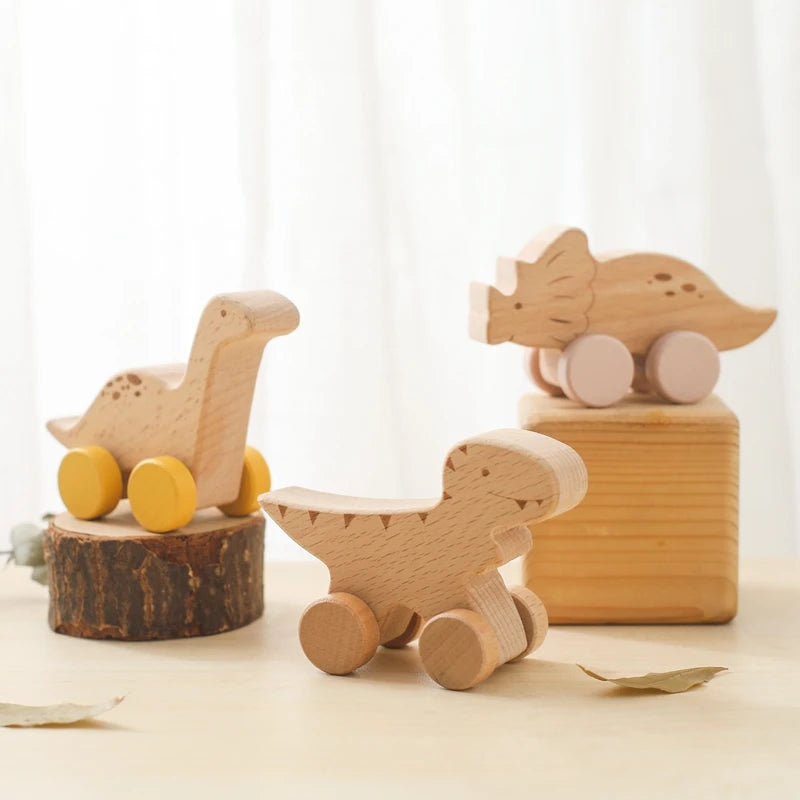 Set of wooden toys including a dinosaur, a fish, and a bird on a light background