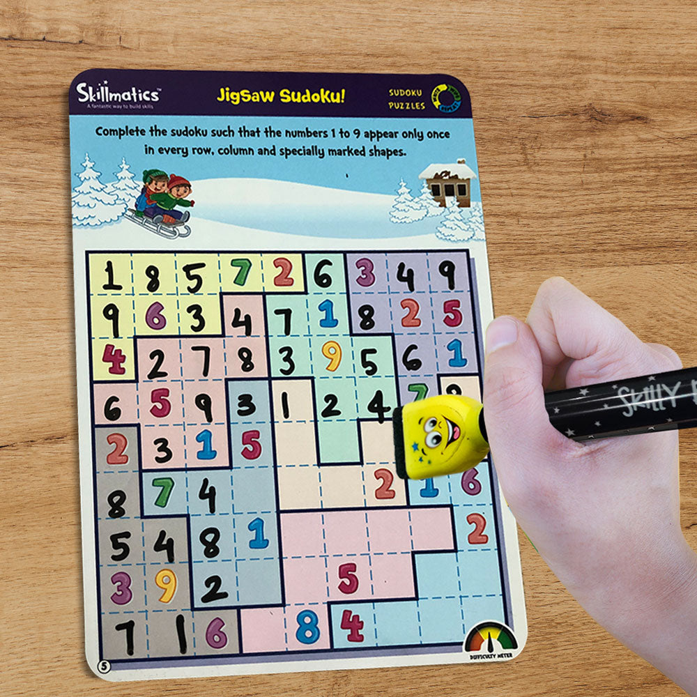 Jigsaw Sudoku puzzle with a hand using a yellow eraser on a wooden surface