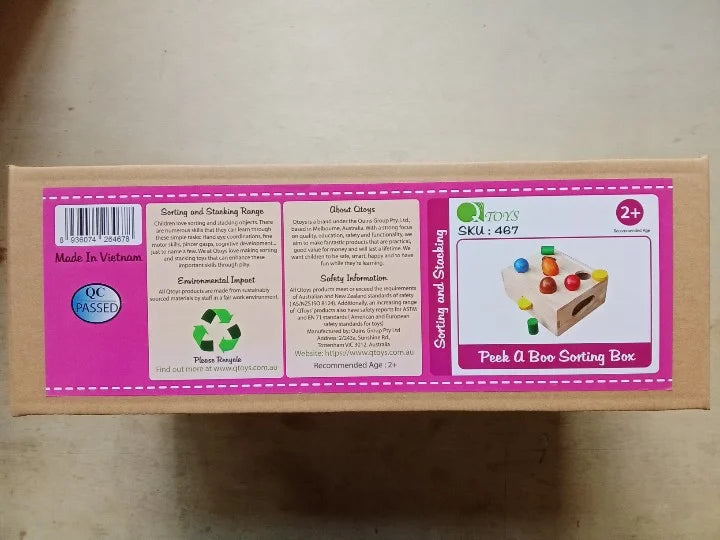 Cardboard box with colorful graphics and text on a wooden surface