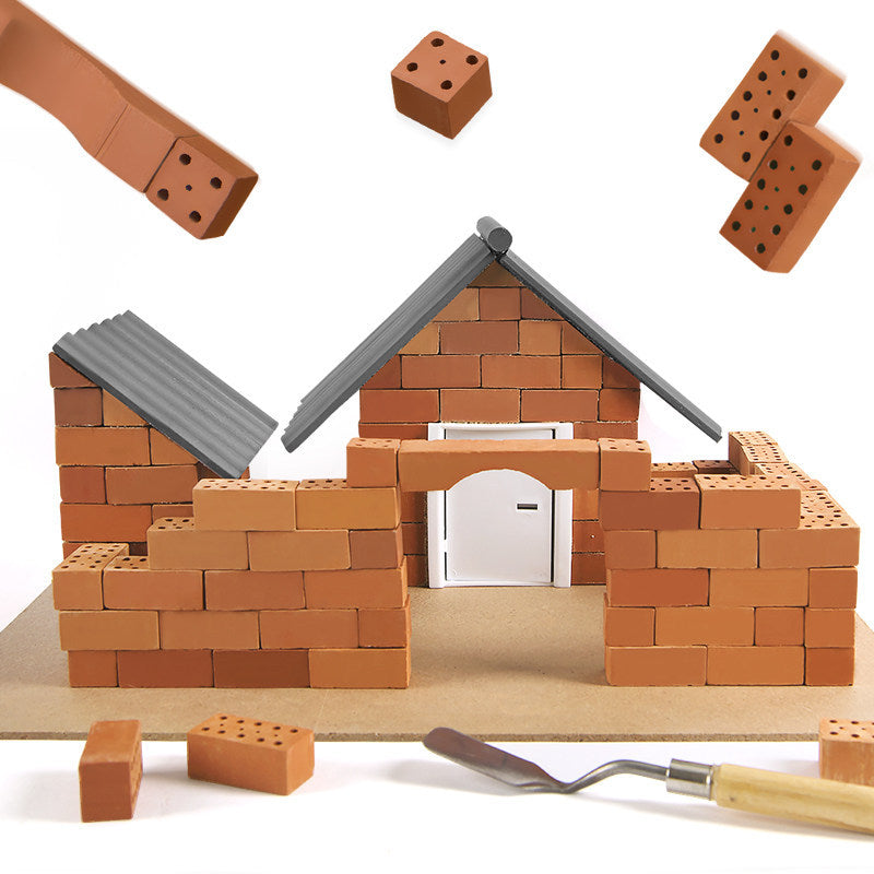 Toy construction set with a house model and tools on a white background