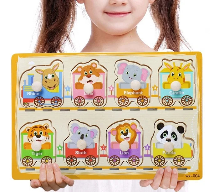 Child holding a educational puzzle with animal illustrations on a white background