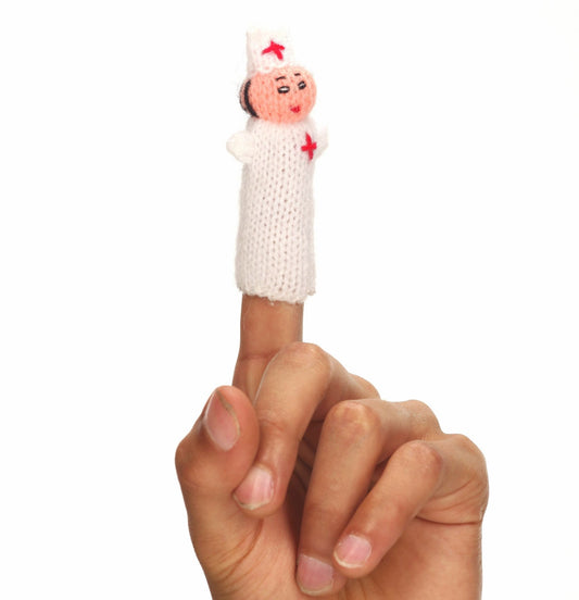Knitted angel finger puppet on a person's finger against a white background