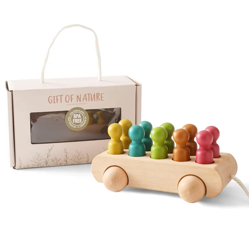 Wooden pull toy with colorful pegs and packaging labeled 'Gift of Nature'.