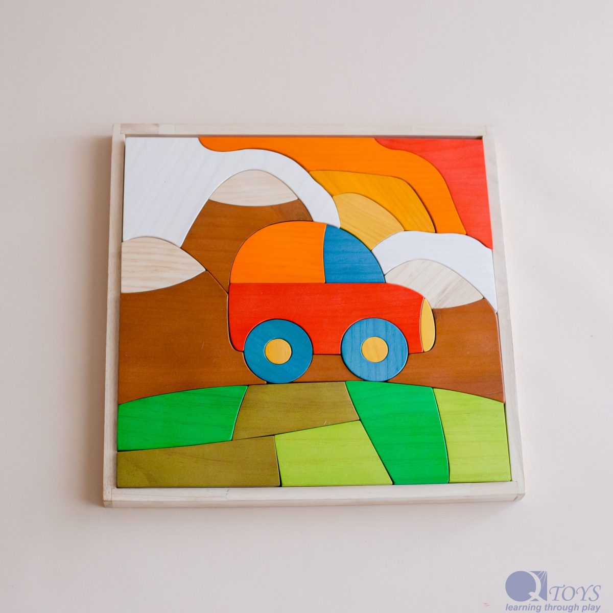 Colorful wooden puzzle with a truck design on a plain background