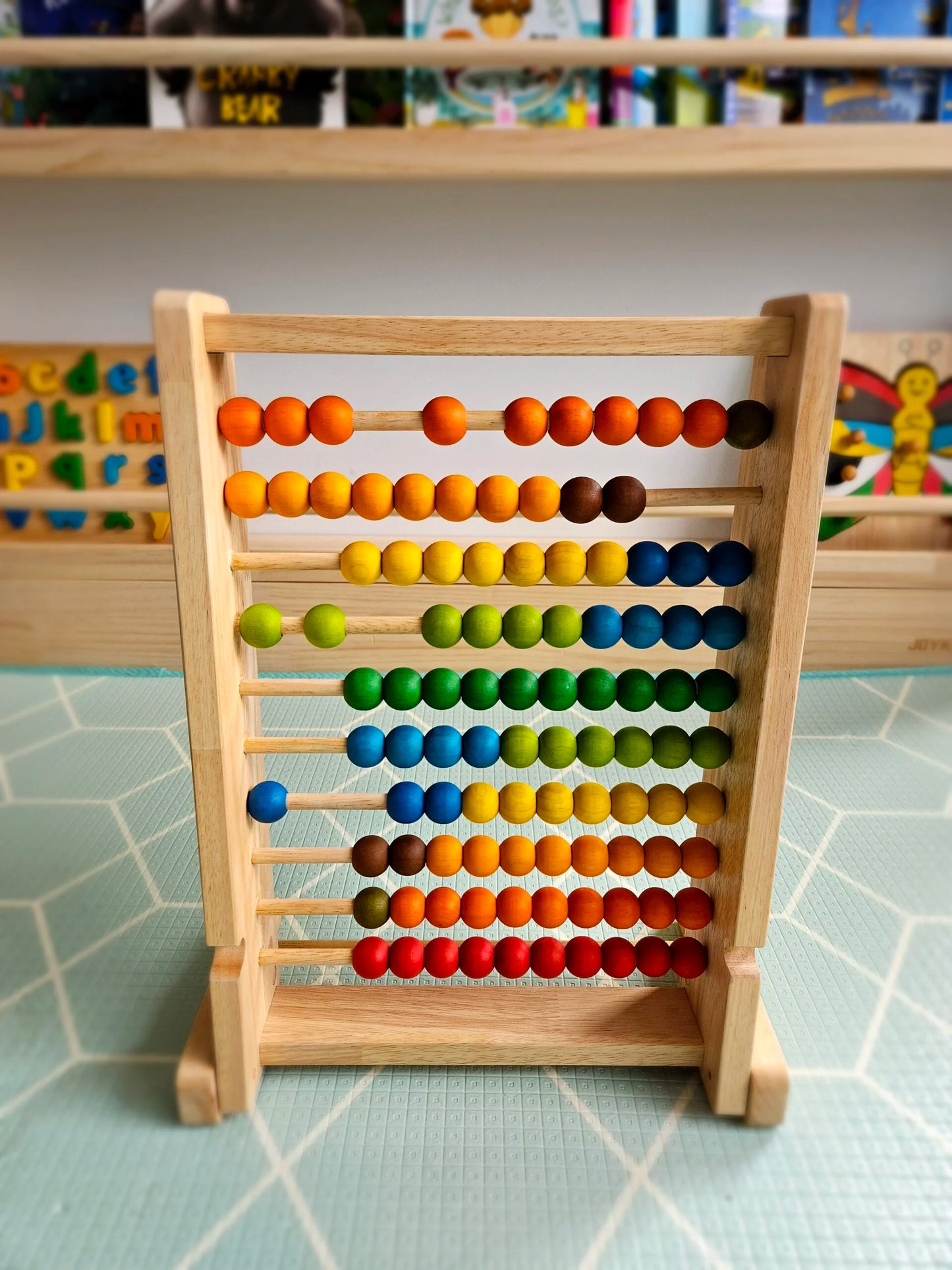 Wooden abacus with colorful beads on a tiled surface
