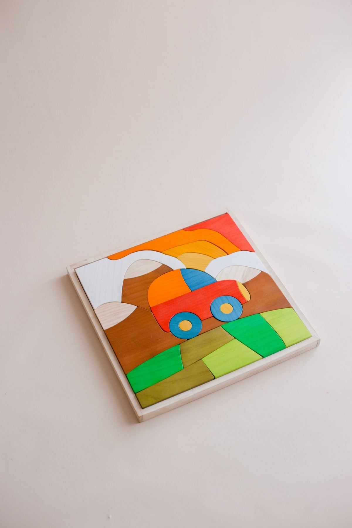 Colorful wooden puzzle with a car design on a white background