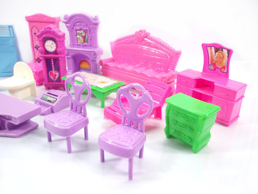 Set of colorful plastic furniture toys on a white background
